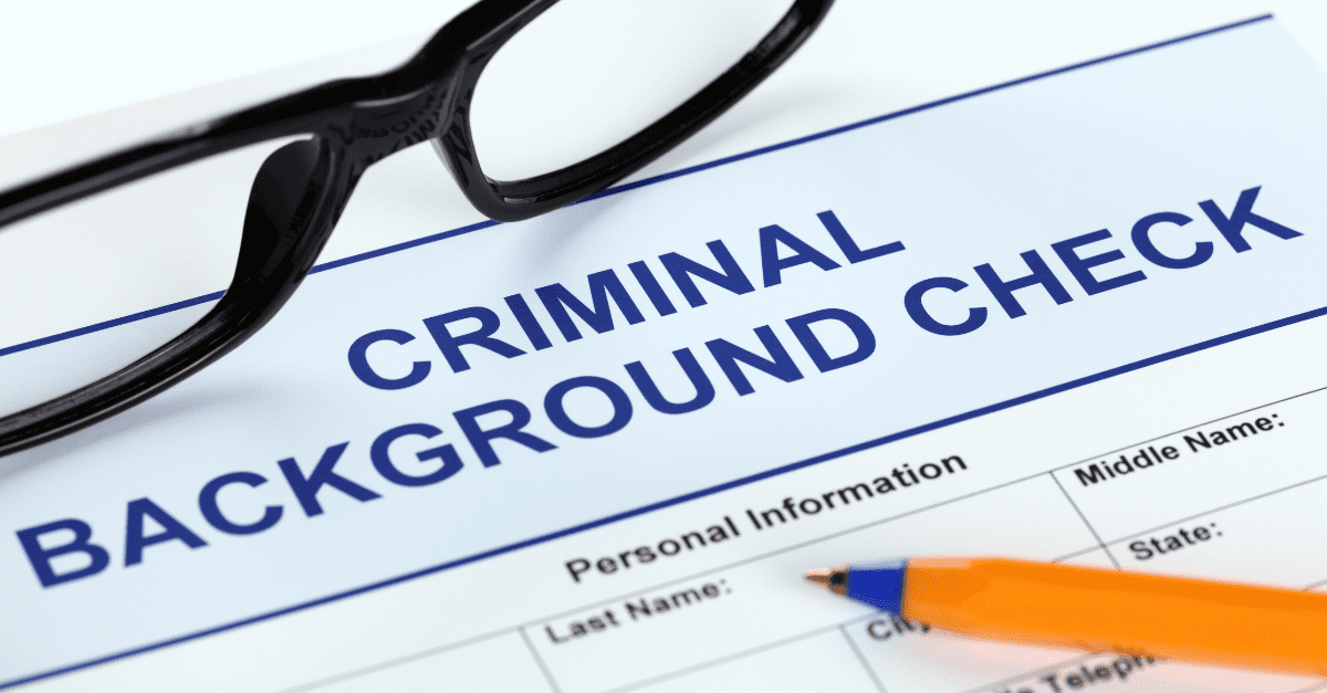 Criminal background check form with a pen and glasses